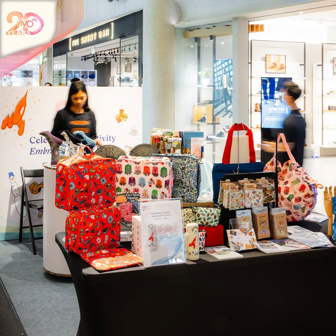 Embroidered tote bags and children's accessories on display
