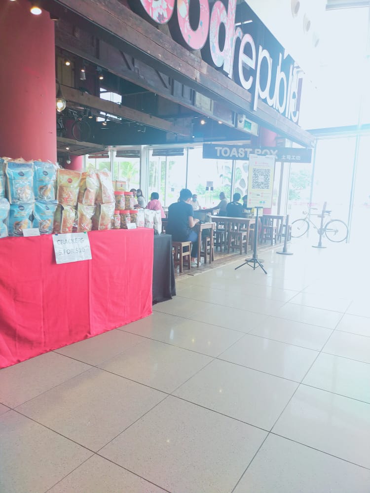 A display of packaged snacks and a seating area inside a brightly lit establishment.