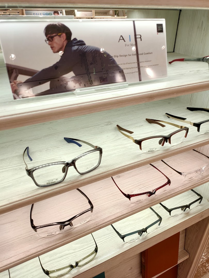 Eyeglasses displayed on shelves with a promotional sign for 'AIR' eyewear.