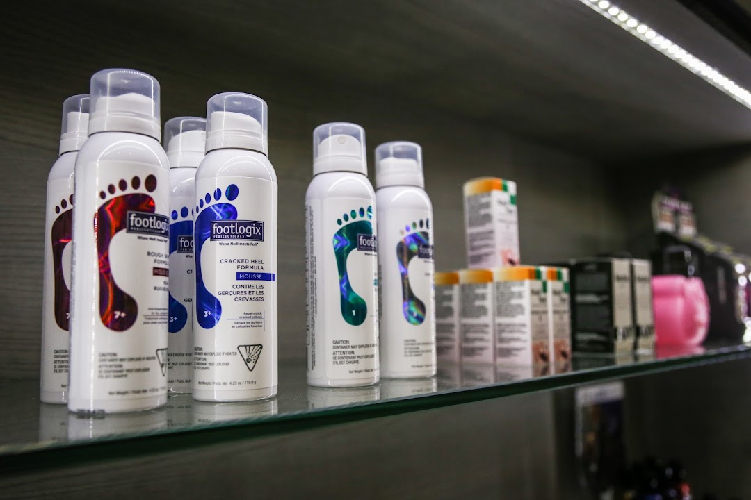 A shelf displaying various Footlogix foot care products, including mousse bottles and other treatments.