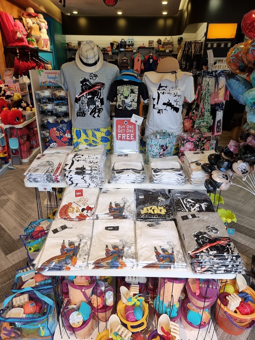 A shop interior displaying Star Wars themed t-shirts and beach toys.